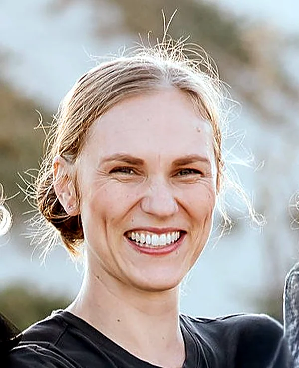 Catherine, Speech Pathologist and founder of Light Unfolding, smiling outdoors